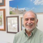 Alex Coles smiling in his office