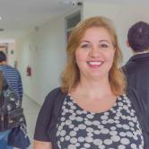 Carla Pousa standing in FSU Panama's hallway