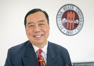Donaldo Fong standing in front of FSU Seal