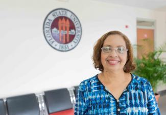 Amarilis Montero standing in front of the FSU Seal